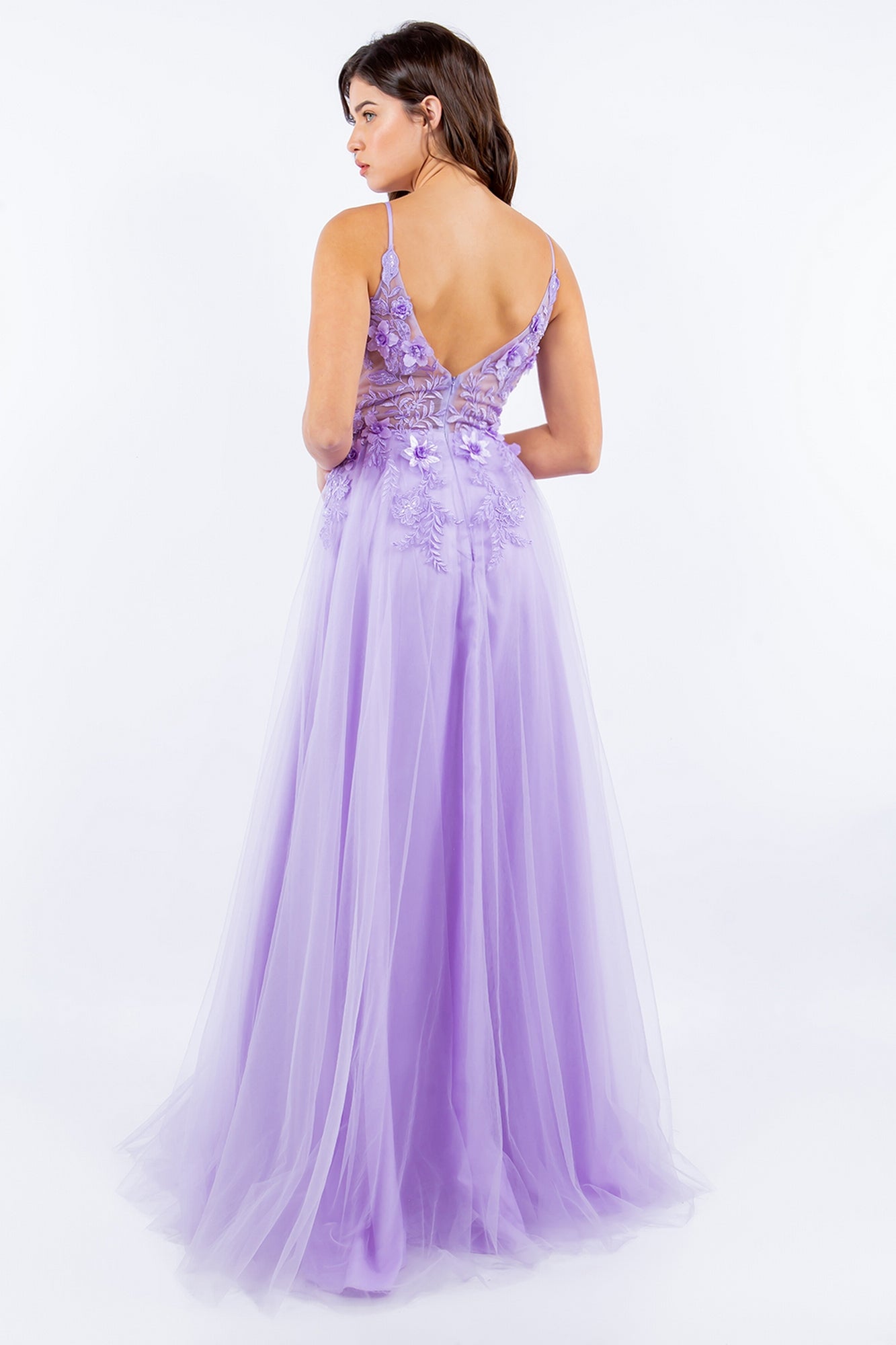 A woman faces away, wearing the Sheer-Bodice Long A-Line Prom Ball Gown 8038J in lavender, featuring a floor-length skirt, sleeveless cut, deep V-back, and intricate 3-D floral bodice designs.